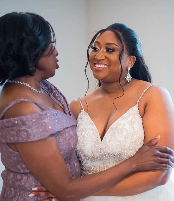 Mother of the bride and bride embracing