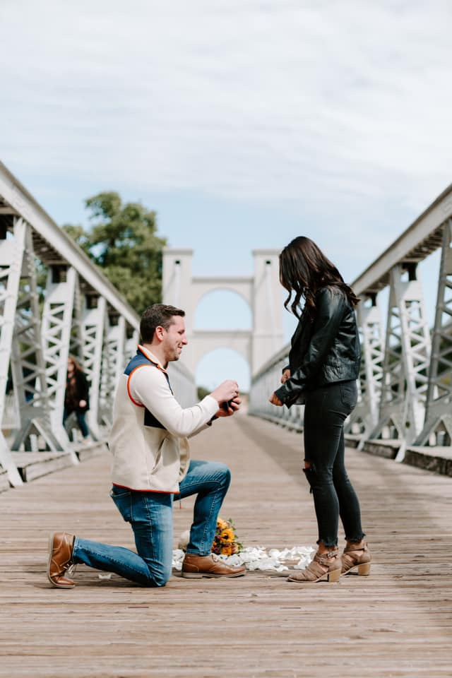 Alex proposing to Tiffani on Waco bridge