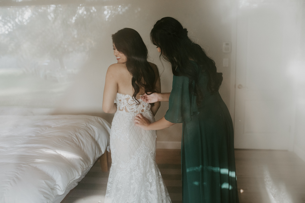 bride and bridesmaid getting ready - ranch wedding in california