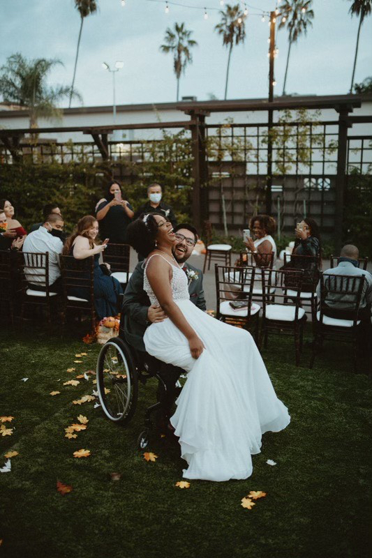 Jordan and Alfonso laughing at reception