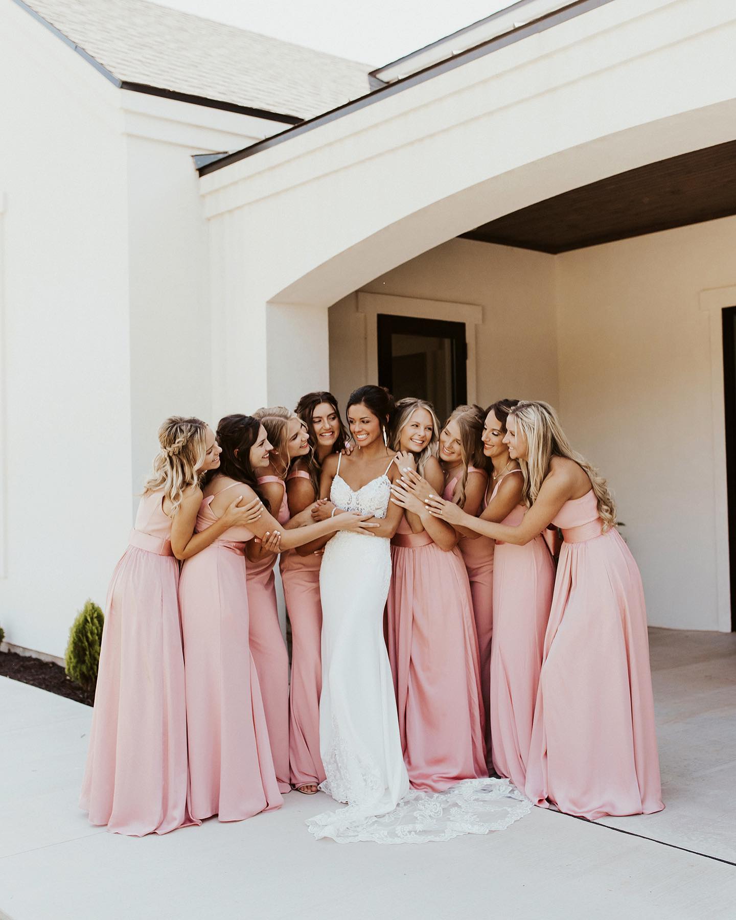 Bride and bridesmaid embracing