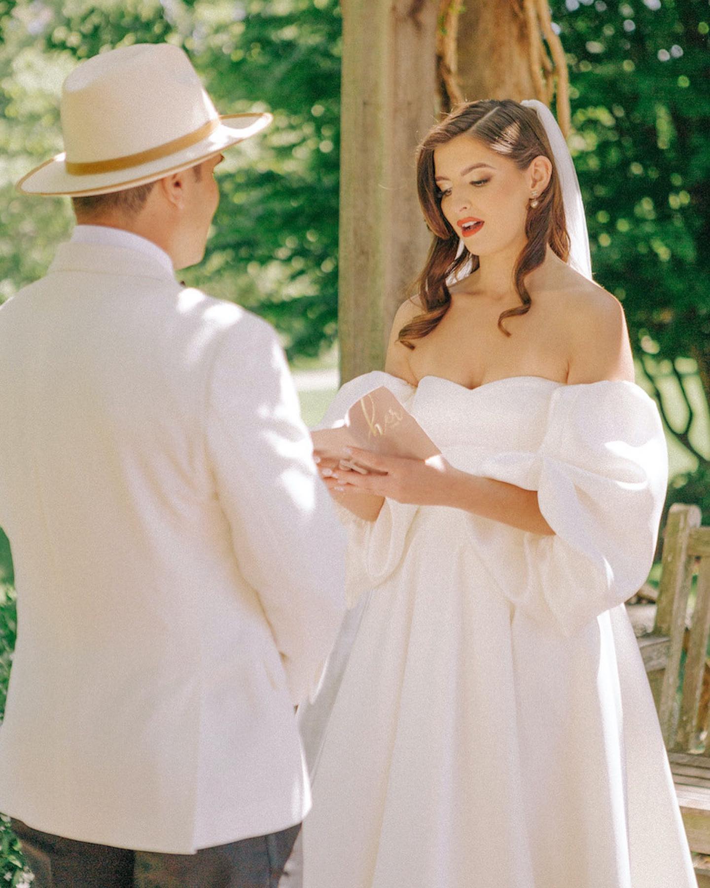 bride and groom reading vows to each other