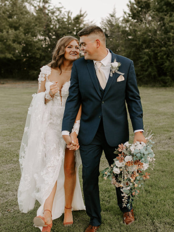 bride and groom walking hand in hand