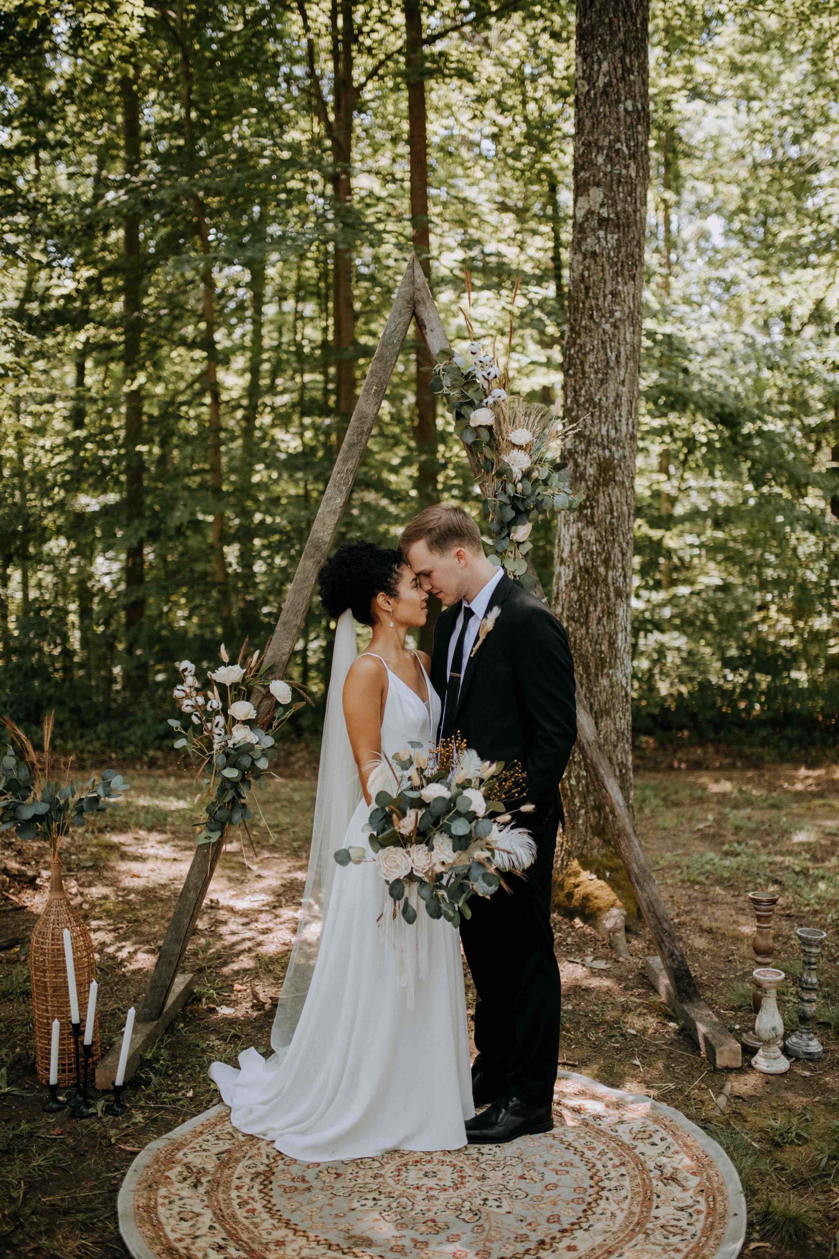 Bride and Groom under wedding ceremony arch