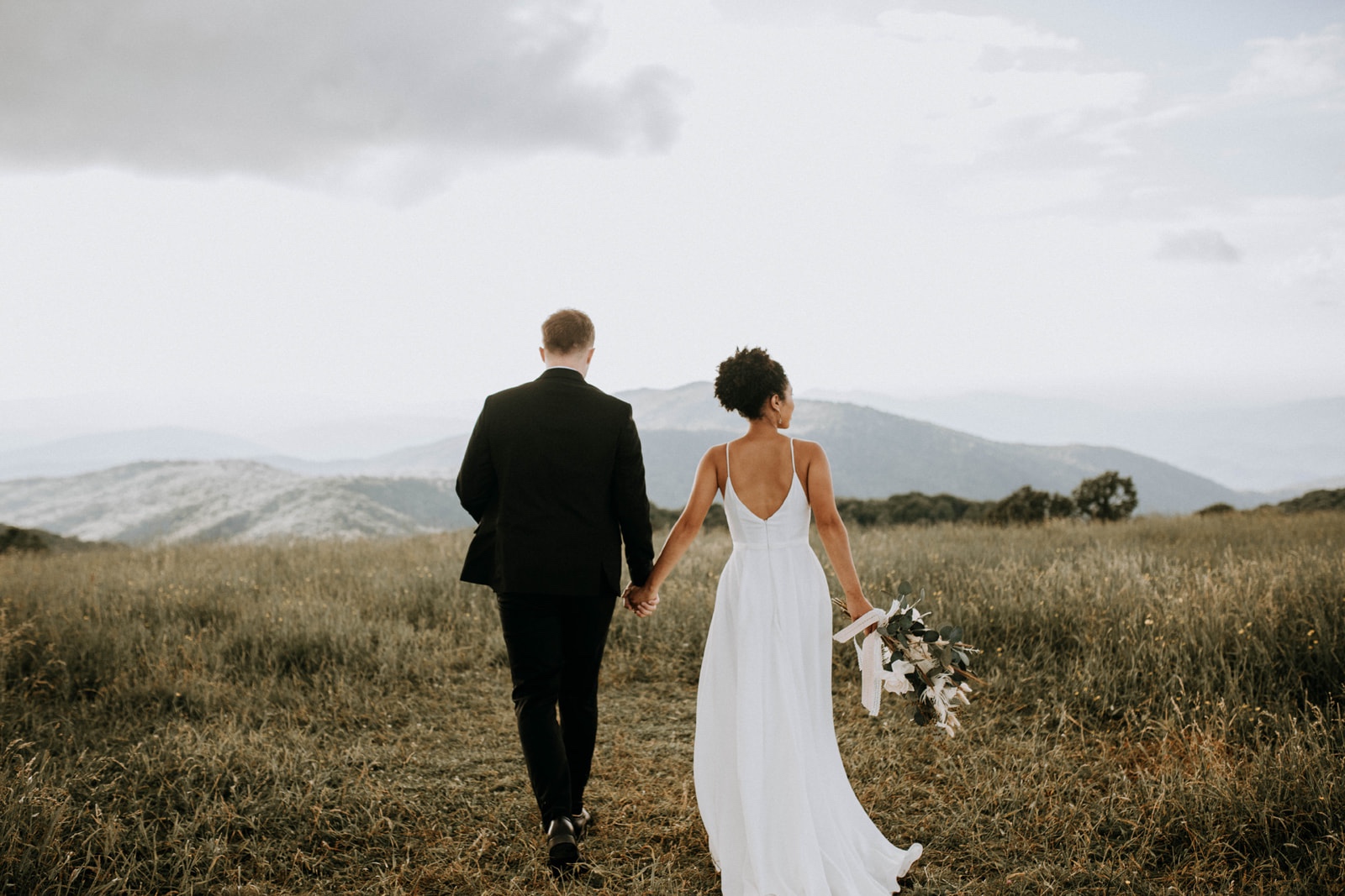 Bride and Groom holding hands and walking away