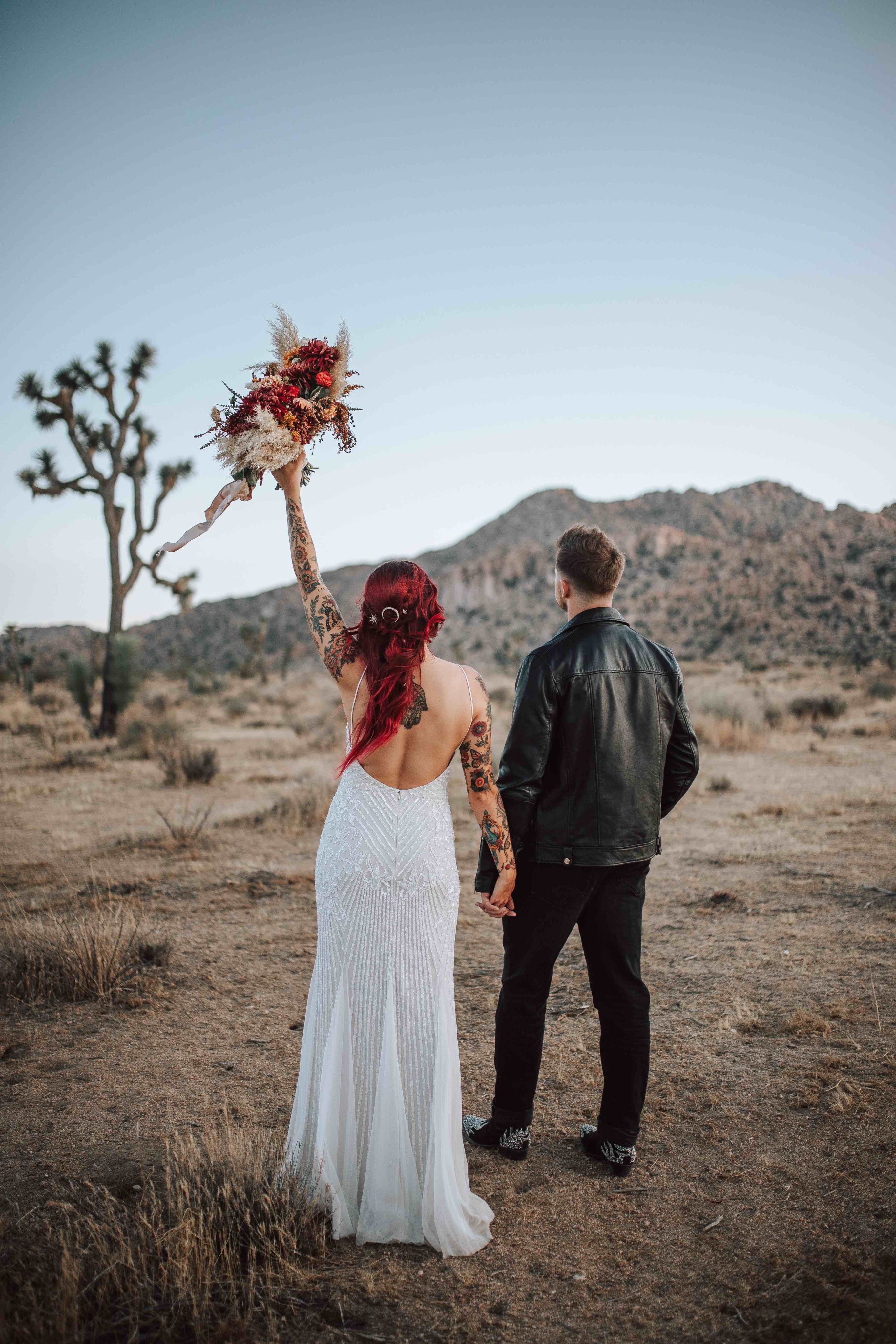 Bride and groom walking off in the desert
