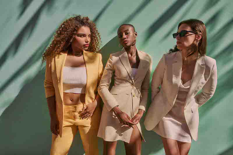 Women in tan and yellow suits