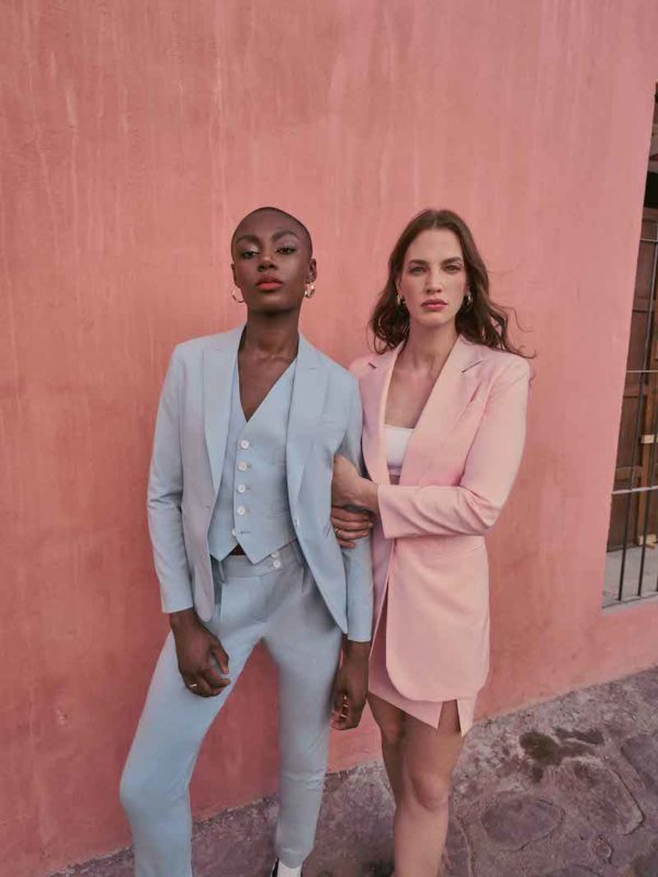 woman in powder blue suit and woman in pink skirt and blazer set