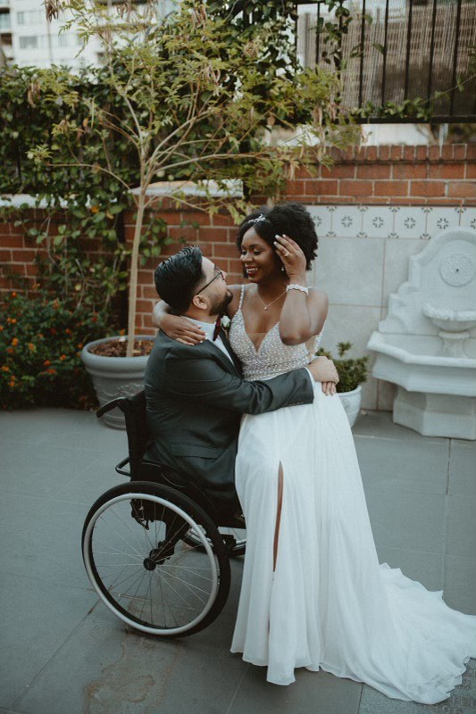 Bride sitting on grooms lap