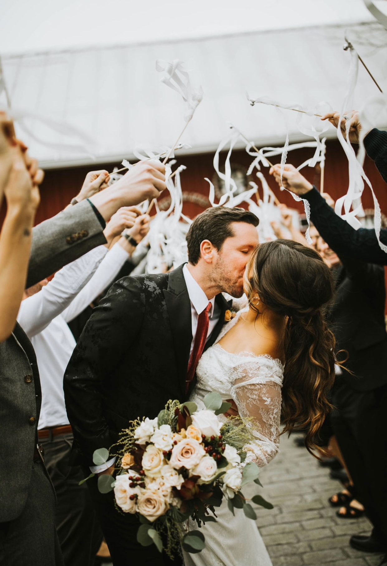 Bride and groom kissing under confetti
