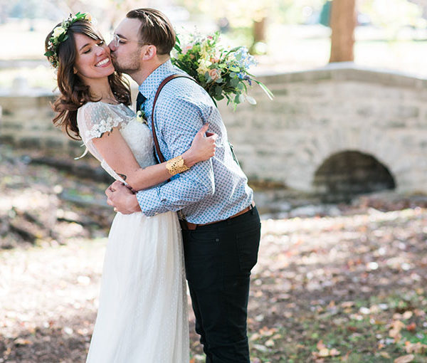 Bride and groom embracing during their outdoor wedding ceremony