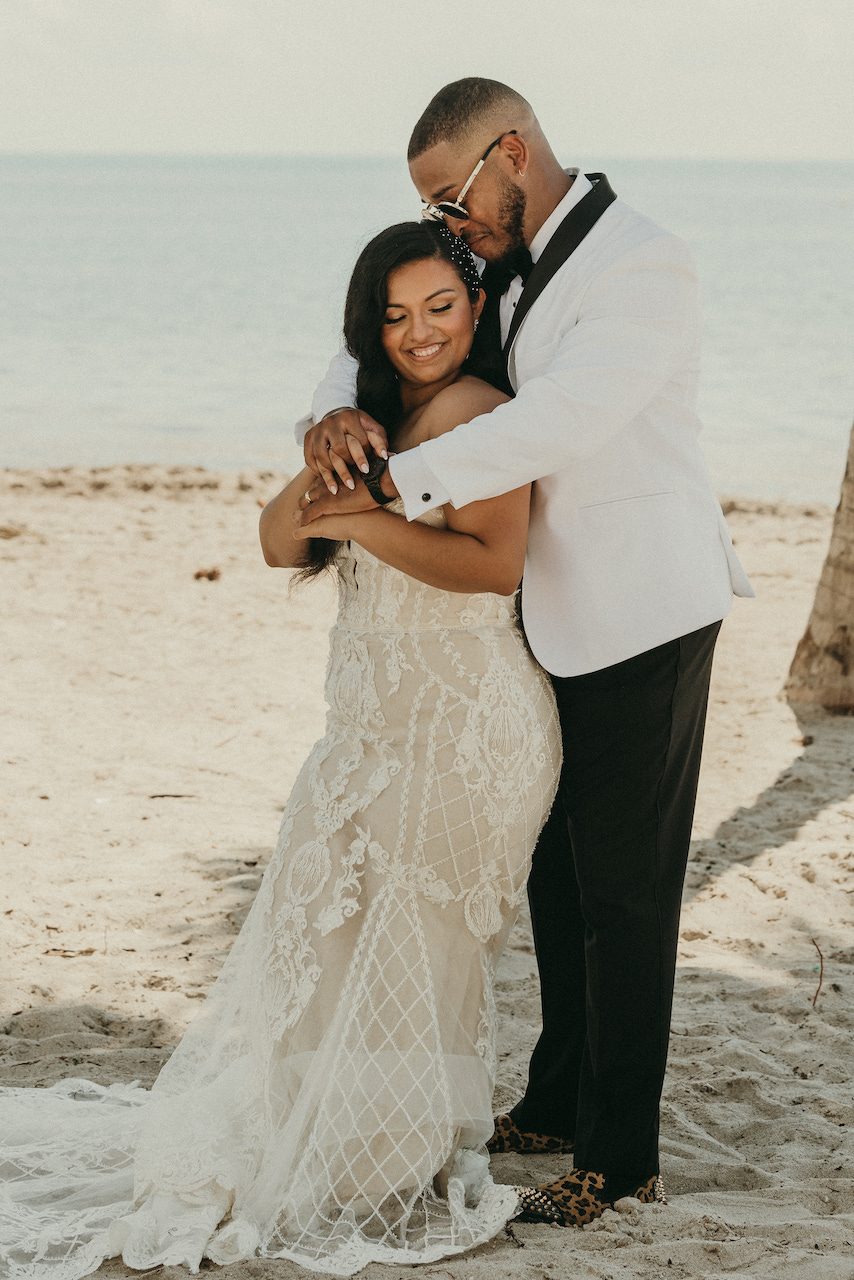 bride and groom kissing at tropical wedding in florida